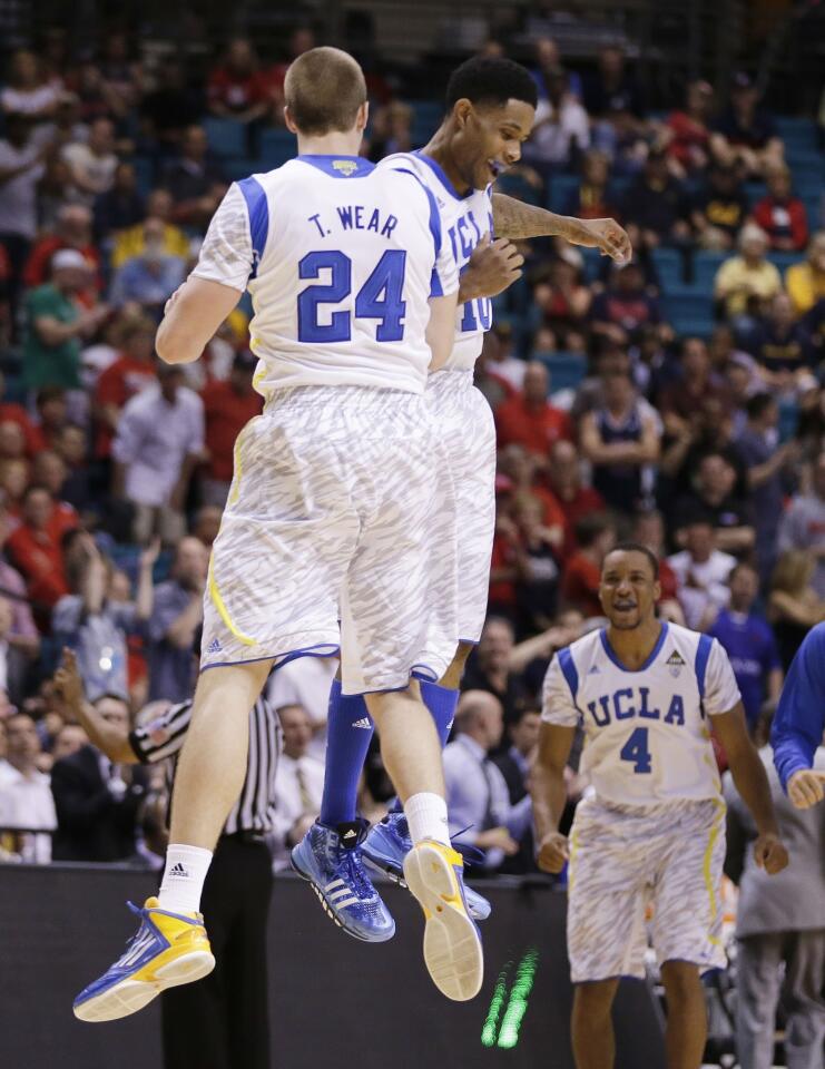 UCLA forward Travis Wear (24) celebrates with point guard Larry Drew II after making a three-point shot to tie the score against Arizona State late in the second half of a Pac-12 Conference tournament game Thursday afternoon at the MGM Grand Garden Arena in Las Vegas.