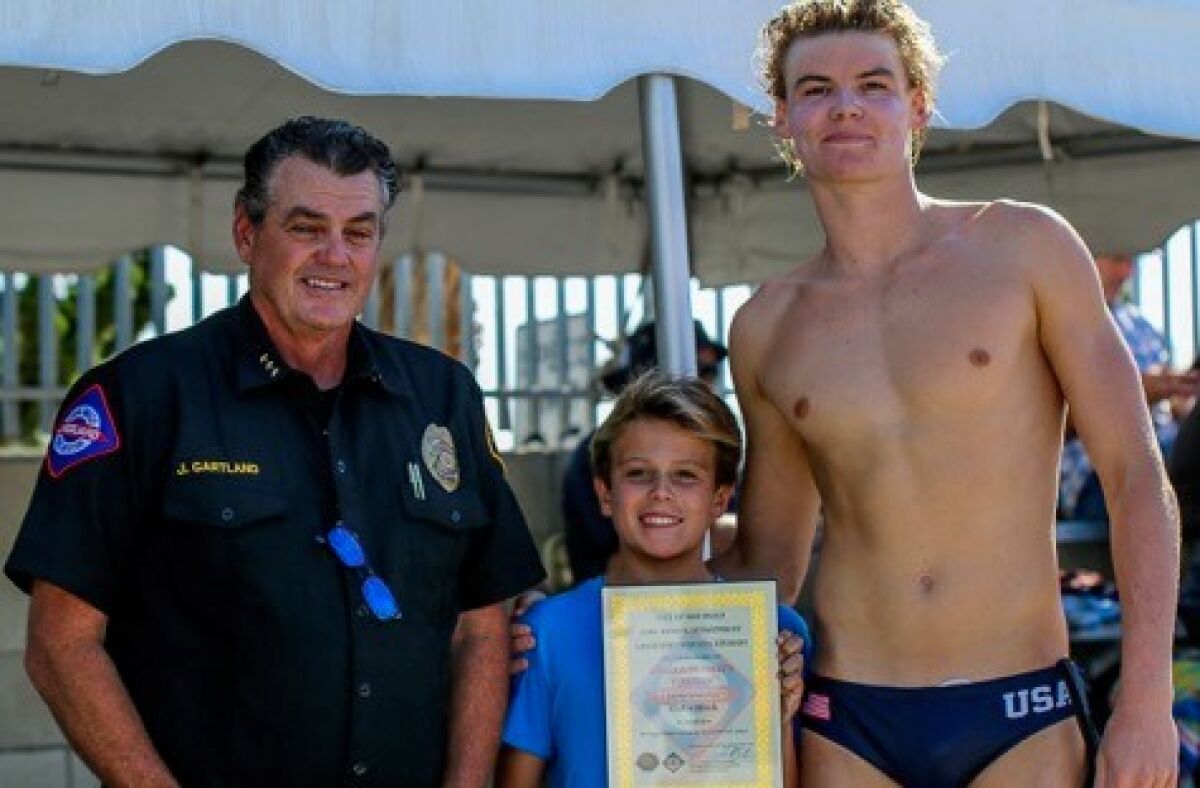 San Diego lifeguard Chief James Gartland, 11-year-old Cortez Jernigan and Kiefer Black
