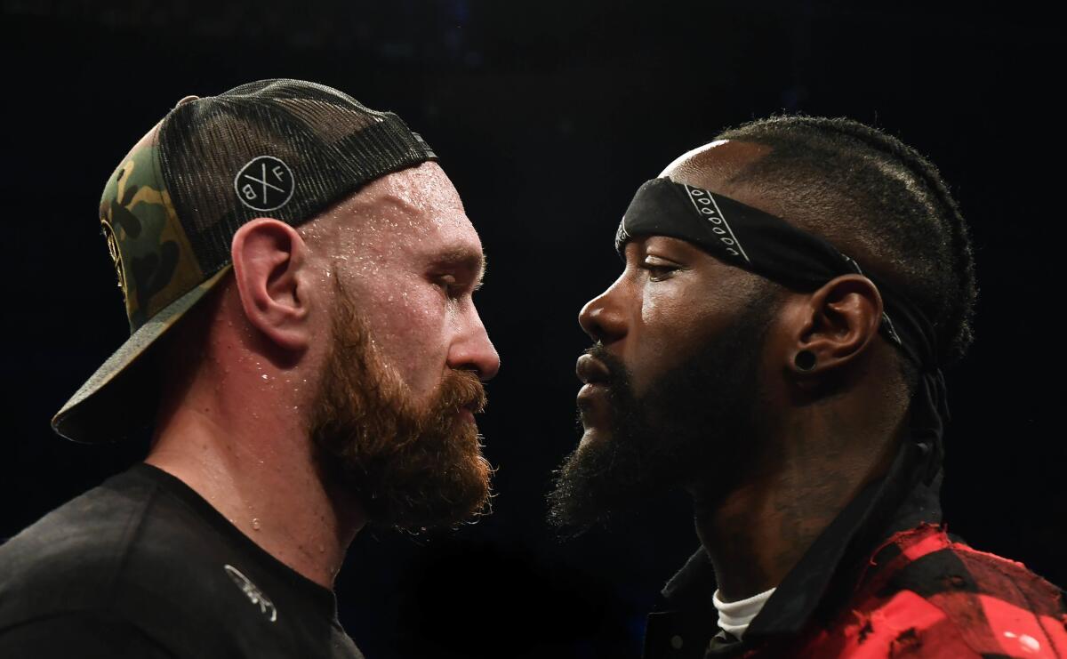 Tyson Fury, left, is confronted by Deontary Wilder after Fury's victory over Francesco Pianeta in a heavyweight contest at Windsor Park on Aug. 18.