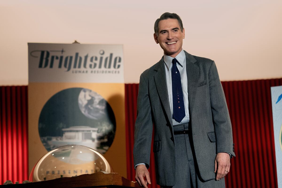 A 1950s salesman presents a poster reading "Brightside."