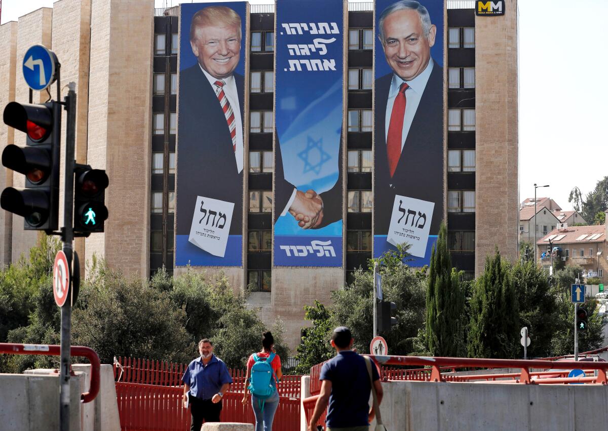 A 2019 election banner in Jerusalem shows Israeli Prime Minister Benjamin Netanyahu shaking hands with President Trump 
