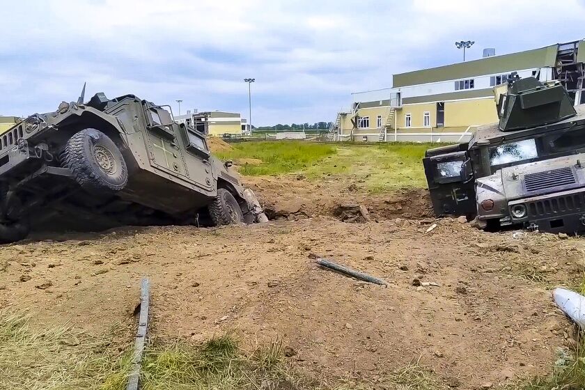 In this image taken from video released by Russian Defense Ministry Press Service, damaged armored military vehicles are seen after fighting in Russia's western Belgorod region on Tuesday, May 23, 2023. Russia alleges that dozens of Ukrainian militants crossed into one of its border towns in its Belgorod region, striking targets and forcing an evacuation, before over 70 of the attackers were killed or pushed back by a counterterrorism operation. (Russian Defense Ministry Press Service via AP)