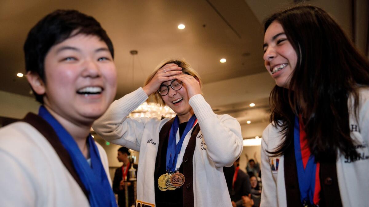 Kendall Kirio, Amy Chung and Britney Burnasky, from West High School, react as their Torrance Unified school wins top honors in the L.A. County academic decathlon at an awards banquet in Montebello.
