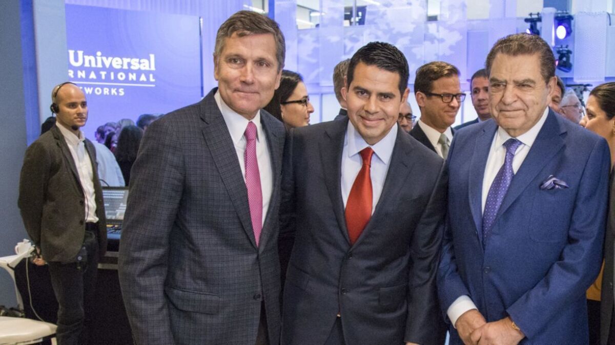 Steve Burke, chief executive of NBCUniversal, left, at Telemundo's building dedication in Miami in April, along with Cesar Conde, chairman of NBCUniversal International Group, center, and Spanish-language TV star Don Francisco.