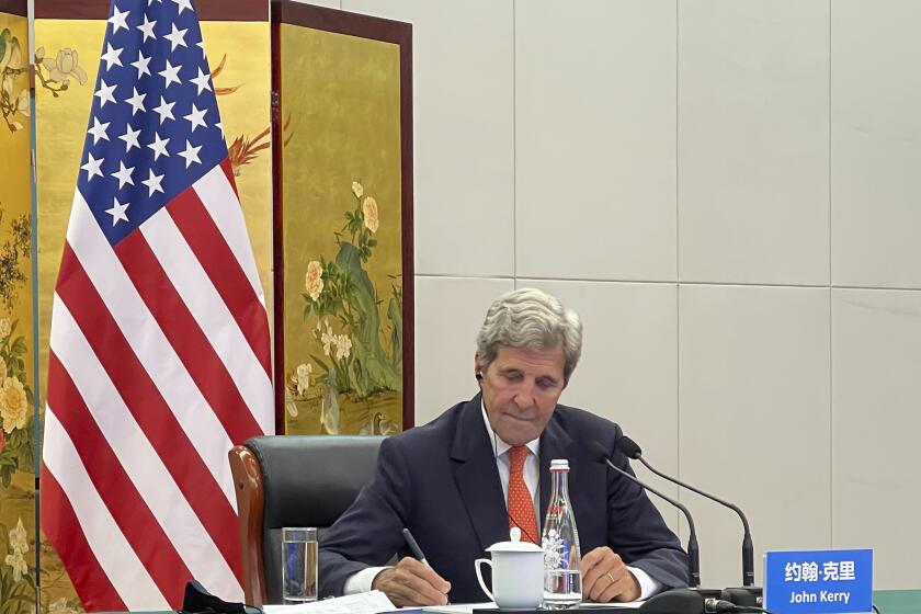 In this photo provided by the U.S. Department of State, U.S. Special Presidential Envoy for Climate John Kerry attends a meeting with Chinese Foreign Minister Wang Yi via video link in Tianjin, China, Wednesday, Sept. 1, 2021. Wang warned Kerry on Wednesday that deteriorating U.S.-China relations could undermine cooperation between the two on climate change. (U.S. Department of State via AP)