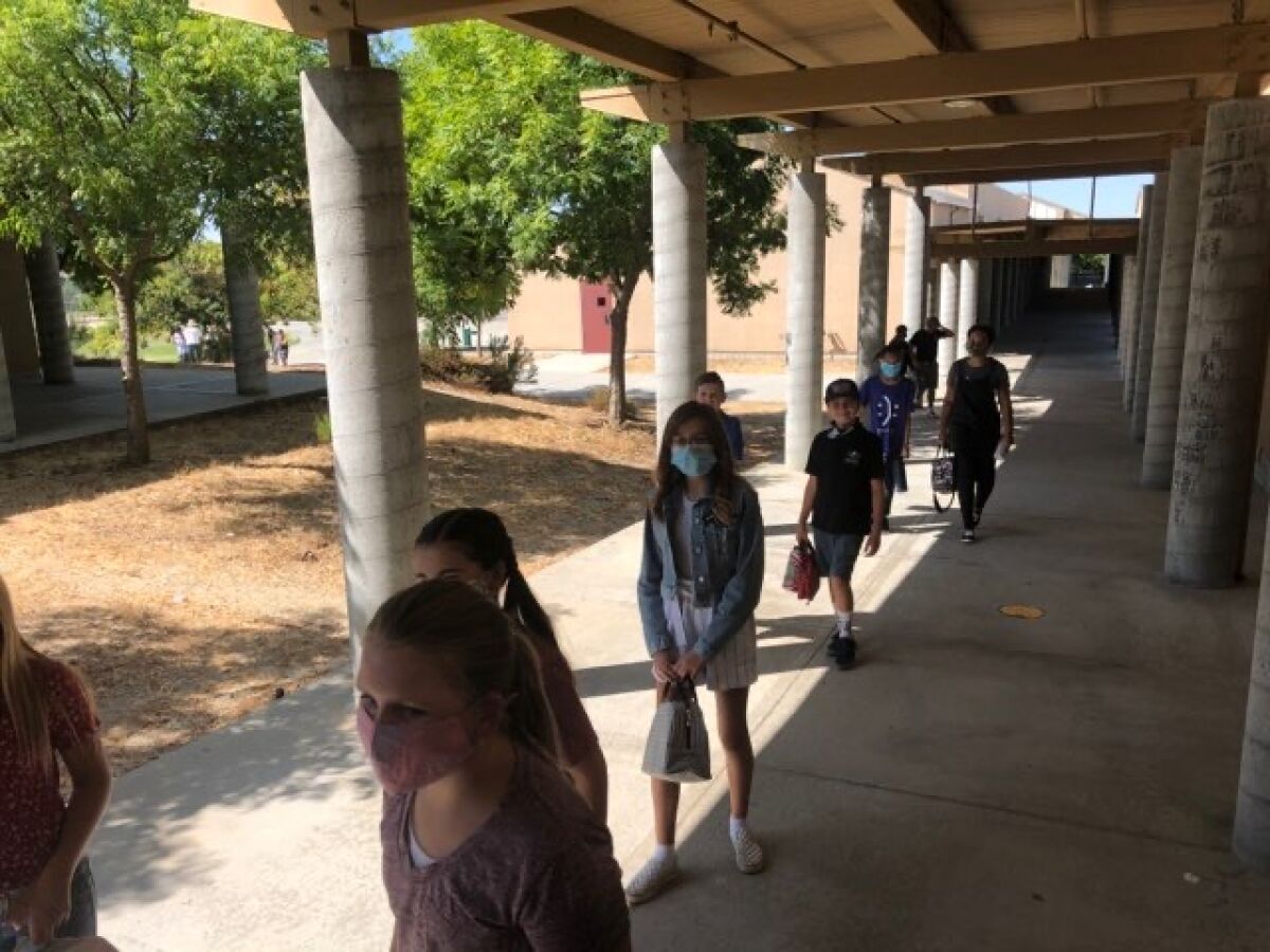 Students line up at Joan McQueen Middle School in Alpine Union School District, which reopened on Sept. 21.