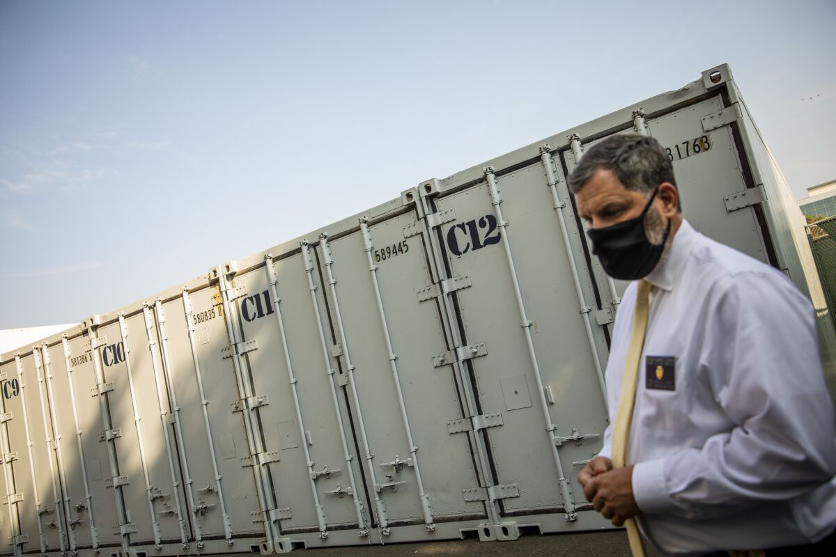 A man in front of a freezer container