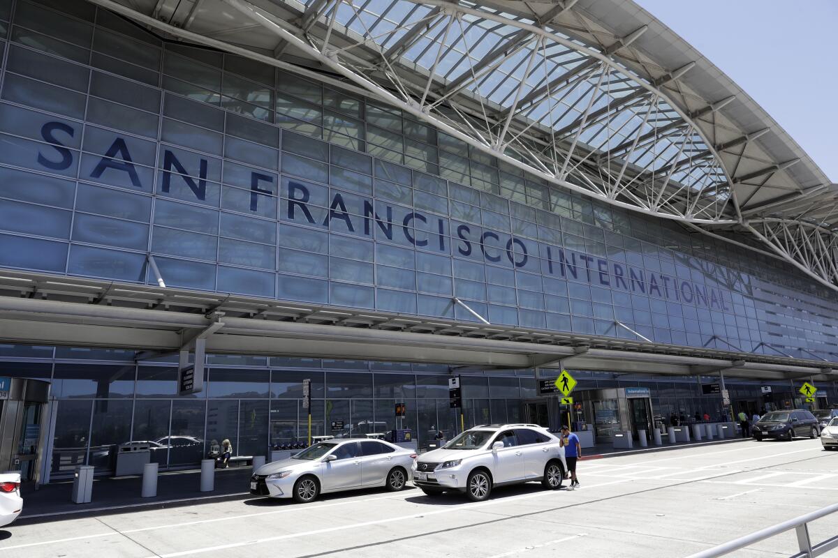 FILE - Vehicles wait outside the international terminal at San Francisco International Airport in San Francisco on July 11, 2017. A worker at the airport was stabbed Tuesday, July 19, 2022, and a suspect was in custody, police said. It is the latest in a series of security incidents at the airport south of San Francisco. (AP Photo/Marcio Jose Sanchez, File)