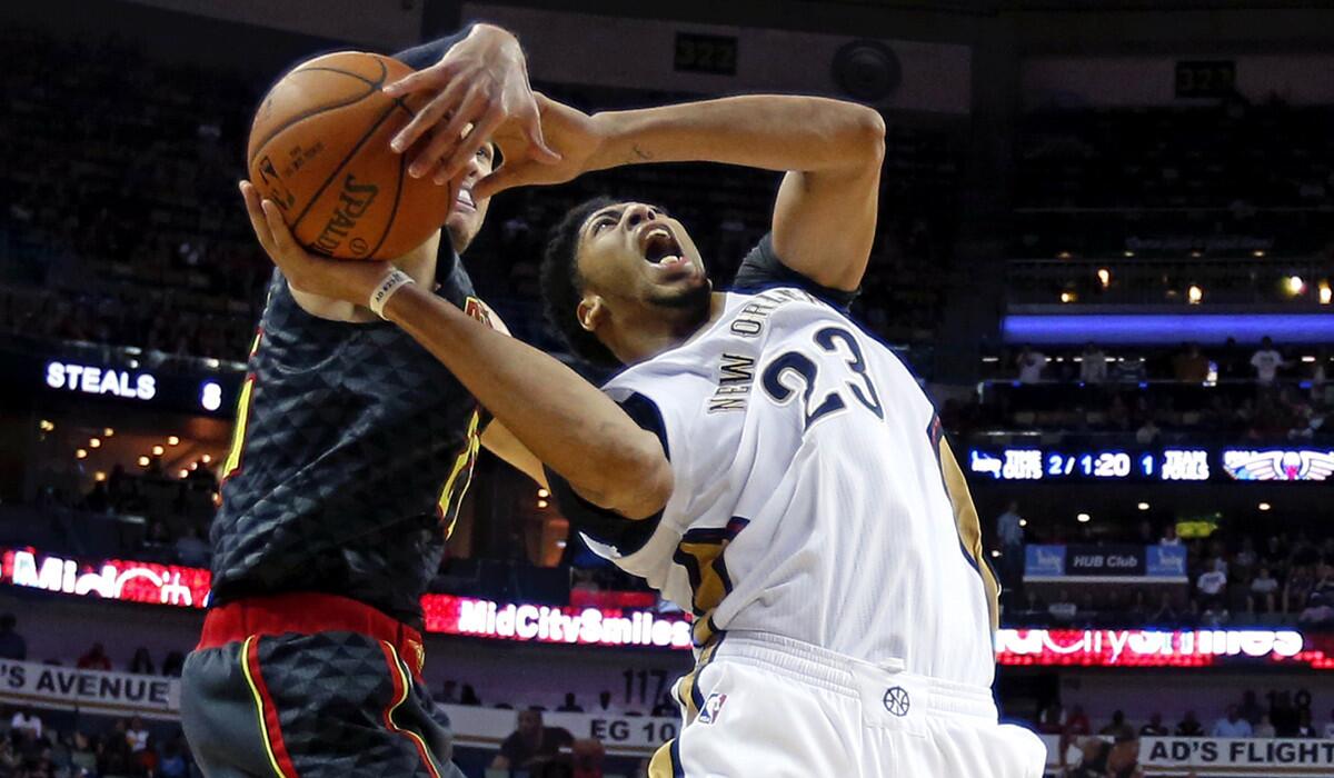 New Orleans Pelicans forward Anthony Davis (23) is stopped by Atlanta Hawks guard Kyle Korver in the second half on Friday.
