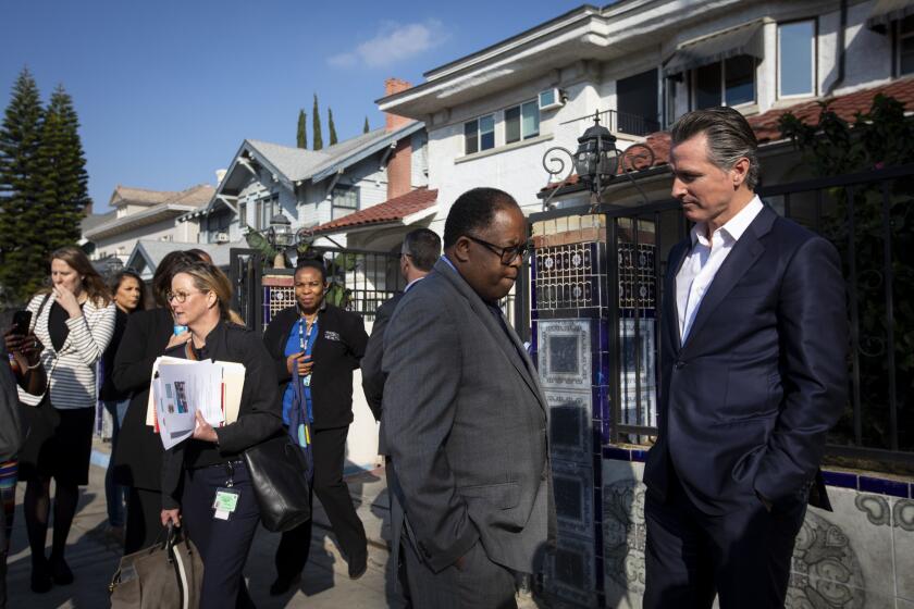 LOS ANGELES, CALIF. - JANUARY 14: Los Angeles County Supervisor Mark Ridley-Thomas, left, and California Gov. Gavin Newsom, right, talk after press confrence at the Lone Star Board and Care in Los Angeles, Calif. on Tuesday, Jan. 14, 2020. Gov. Gavin Newsom is also visiting a board and care as part of his week long homelessness tour. (Francine Orr / Los Angeles Times)