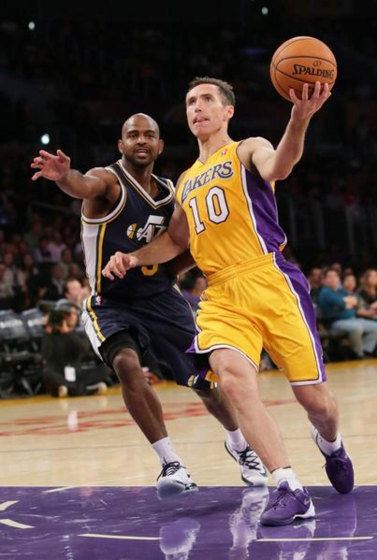 Lakers point guard Steve Nash did not play in the second half of the team's 113-90 loss to the Minnesota Timberwolves on Sunday because of persistent pain in his back.