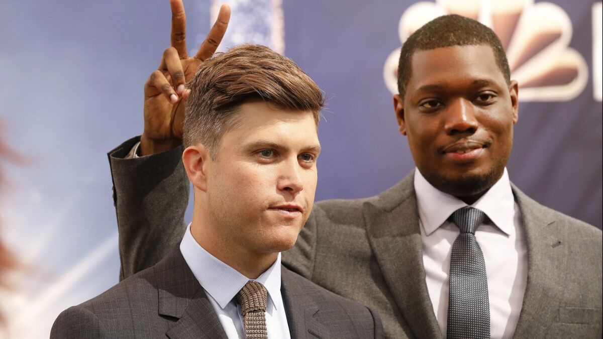 Colin Jost, left, and Michael Che anchor "Weekend Update" on a resurgent "Saturday Night Live," but critics question whether they're the right choice to host the Emmys.