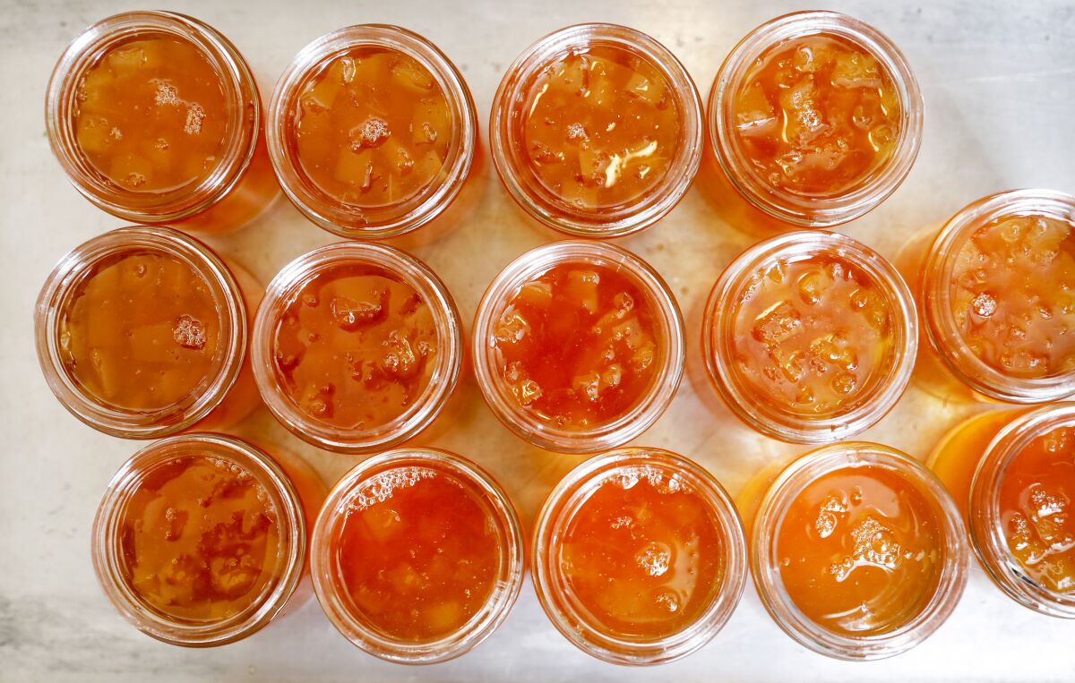Several glass jars of oro blanco grapefruit marmalade.