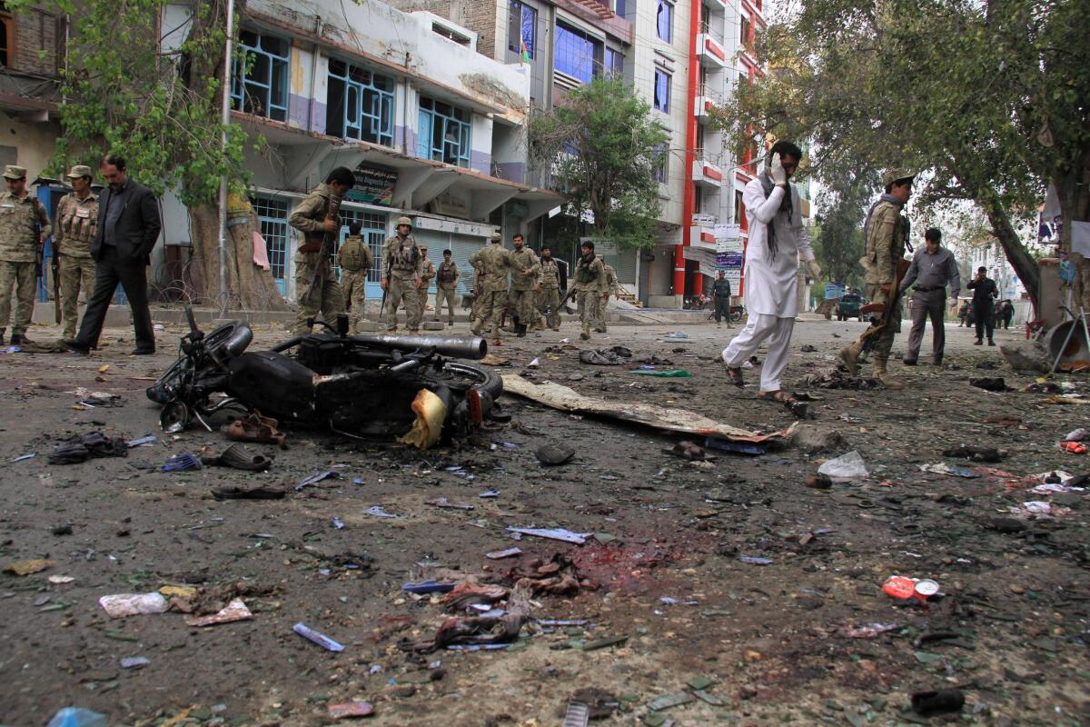 Afghan security officials inspect the scene of a suicide bomb attack in Jalalabad, Afghanistan, on April 18 2015.