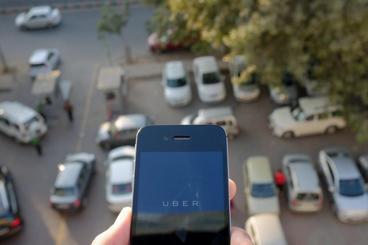 The Uber smartphone app is pictured over a parking lot in the Indian capital of New Delhi on Dec. 7.