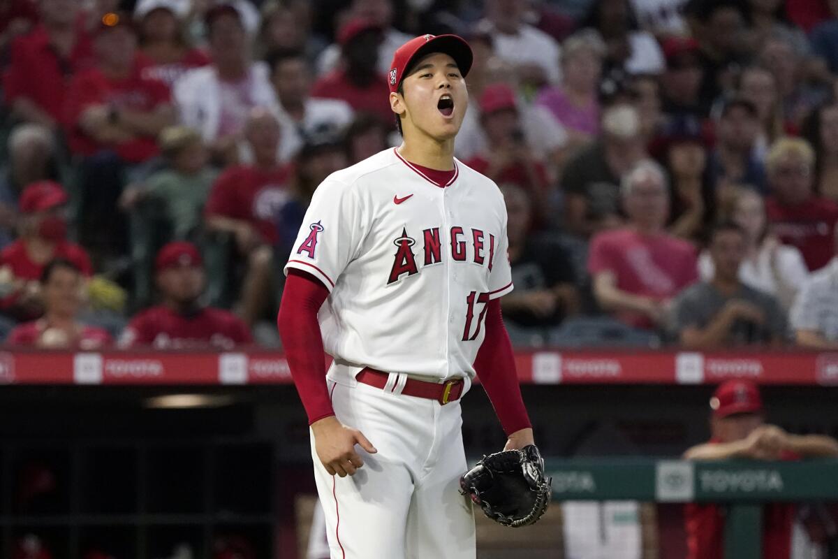 Los Angeles Angels starting pitcher Shohei Ohtani reacts after Toronto Blue Jays' George Springer grounded into a double play during the third inning of a baseball game Thursday, Aug. 12, 2021, in Anaheim, Calif. (AP Photo/Marcio Jose Sanchez)