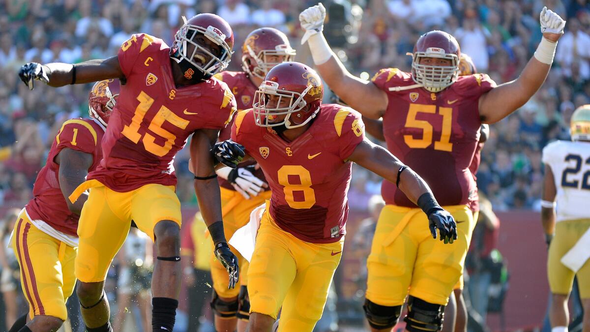 USC wide receiver Nelson Agholor, left, celebrates after scoring a touchdown with teammate George Farmer during a win over Notre Dame on Nov. 29.