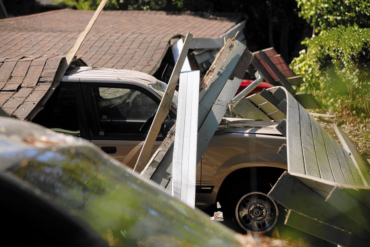 Cars were flattened when the quake damaged a carport at Charter Oaks Apartments in Napa.