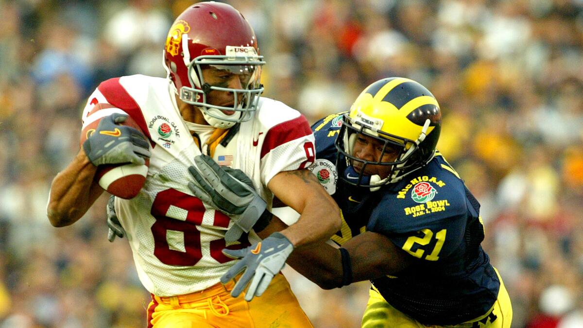 Keary Colbert makes a one-handed catch against Michigan defensive back Jeremy LeSueur to score a touchdown in the Rose Bowl on Jan. 1, 2004.