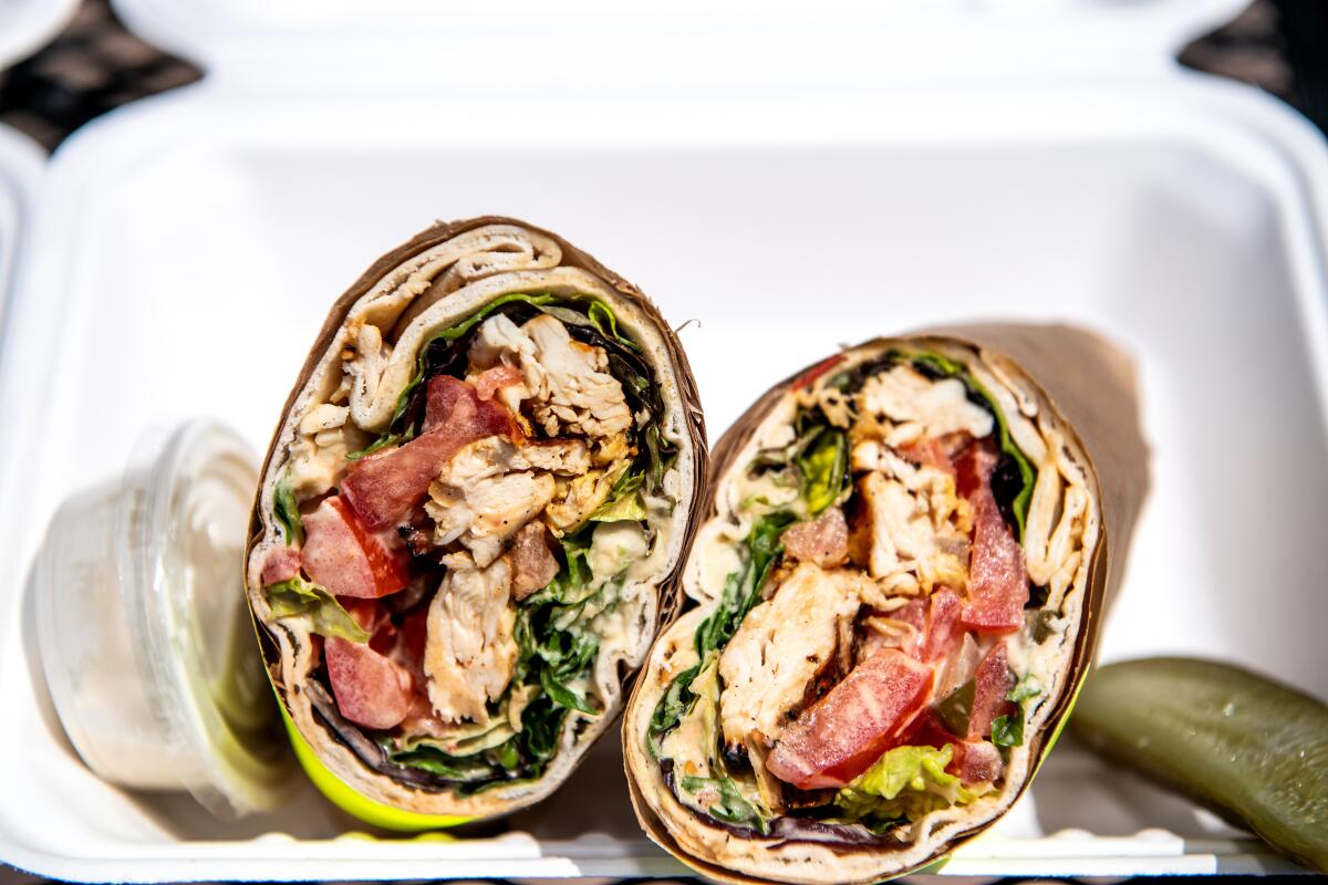 ANAHEIM, CA - APRIL 17: Chicken specialty wrap from Kareem's Falafel on Friday, April 17, 2020 in Anaheim, CA. Originally founded by their parents 25 years ago, siblings Nora and Kareem Hawari are now working to keep their family business afloat during the Coronavirus pandemic. (Mariah Tauger / Los Angeles Times)