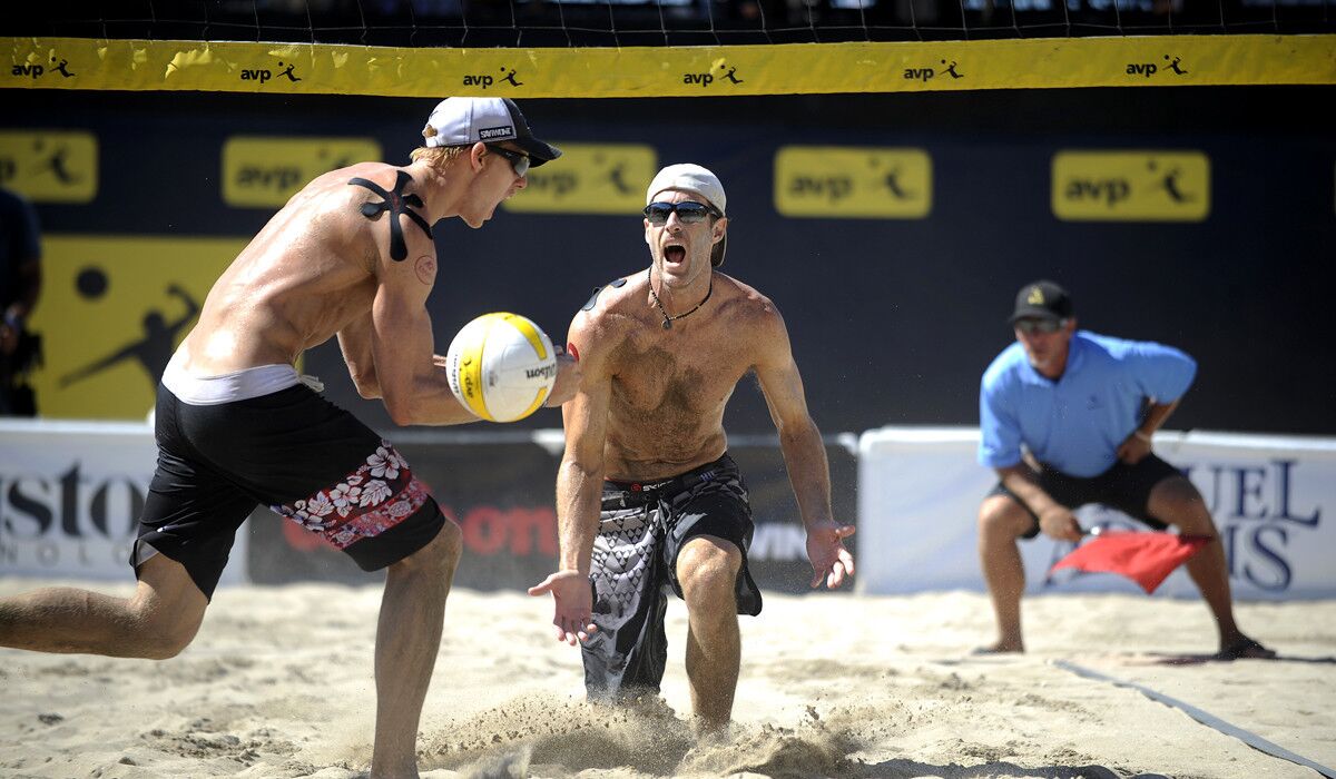 Tri Bourne, left, and John Hyden compete in the Men's finals of the AVP Championships in Huntington Beach on Sunday.