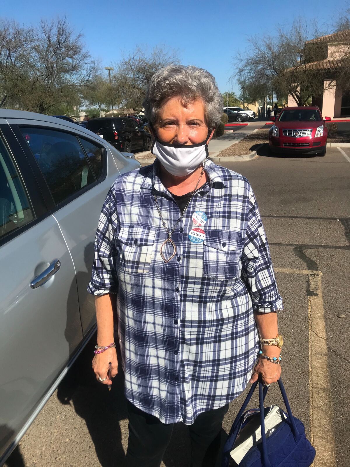 Linda Cottrell stands in a parking lot after voting in Arizona.