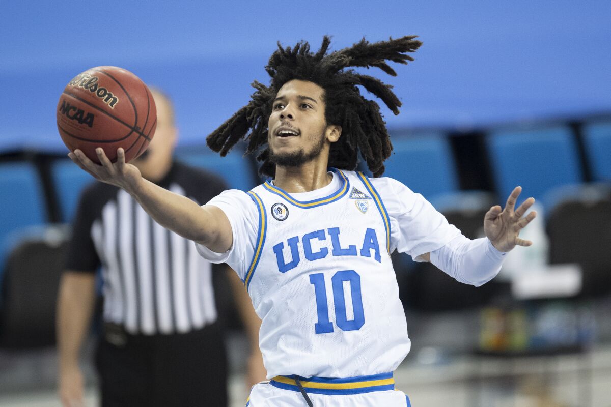 UCLA guard Tyger Campbell goes up for a basket.