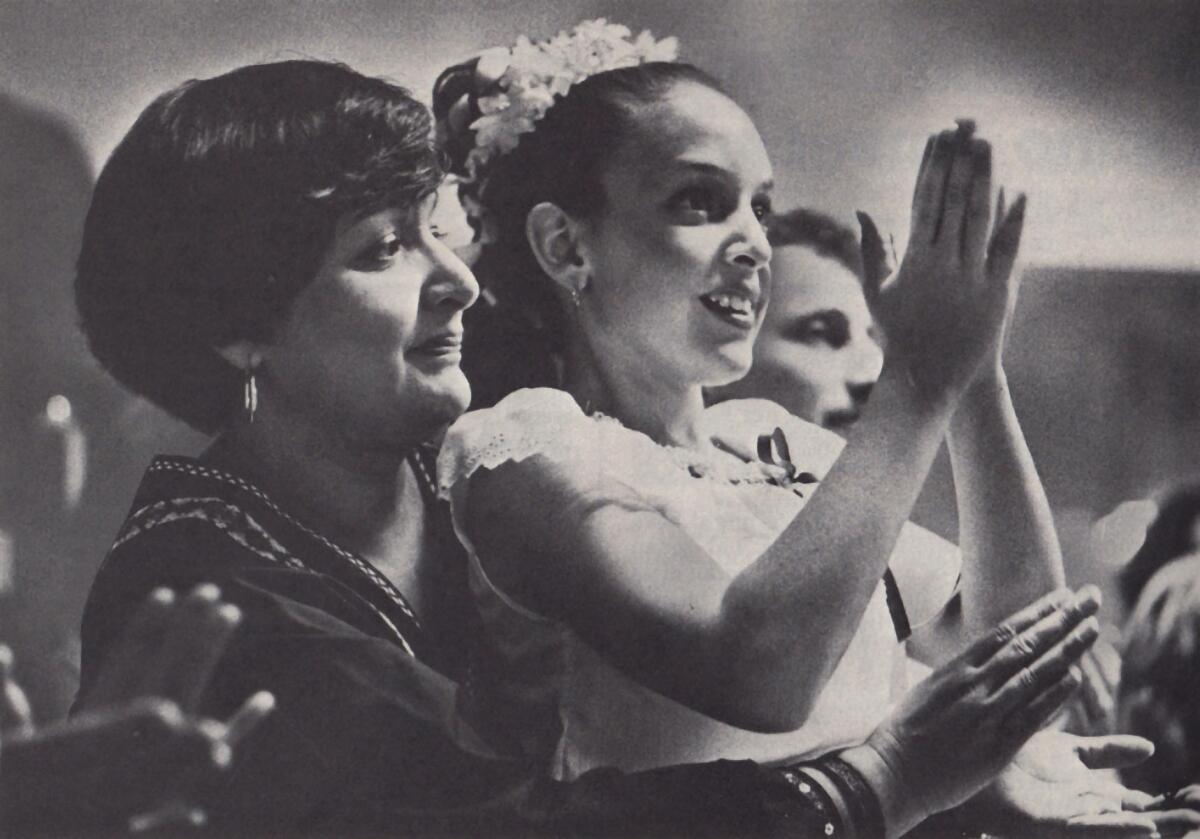 Barbara Brown and daughter Samantha attend a Mexican dance. Such events help Latinos to hold on to their cultural traditions.