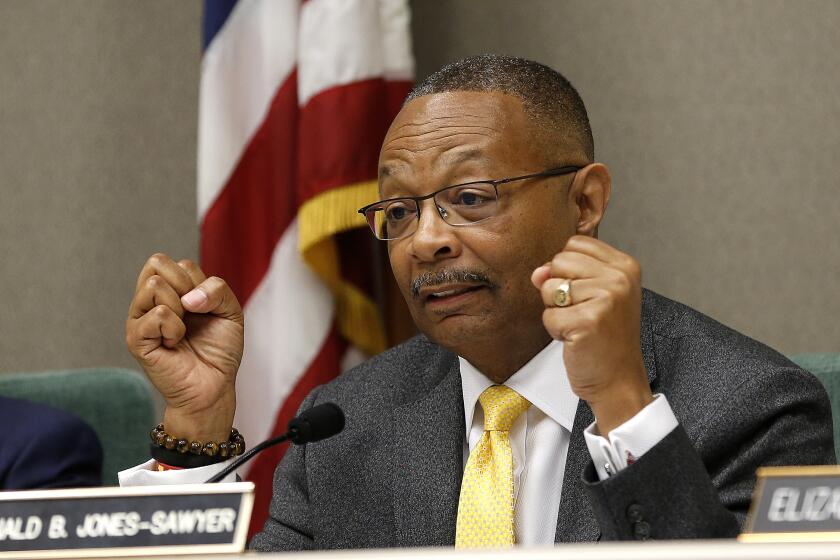 FILE - In this April 9, 2019 file photo, Assemblyman Reginald Jones-Sawyer, D-Los Angeles, chairman of the Assembly Public Safety Committee, discusses legislation to restrict the use of deadly force by police, during a hearing on the measure in Sacramento, Calif. The California Correctional Peace Officers Association literally put a target on Democratic Assemblyman Reggie Jones-Sawyer of Los Angeles in a 59th Assembly District campaign ad the union quickly withdrew admit criticism. As chairman of the Assembly Public Safety Committee, Jones-Sawyer has promoted policies to reduce mass incarceration. (AP Photo/Rich Pedroncelli, File)