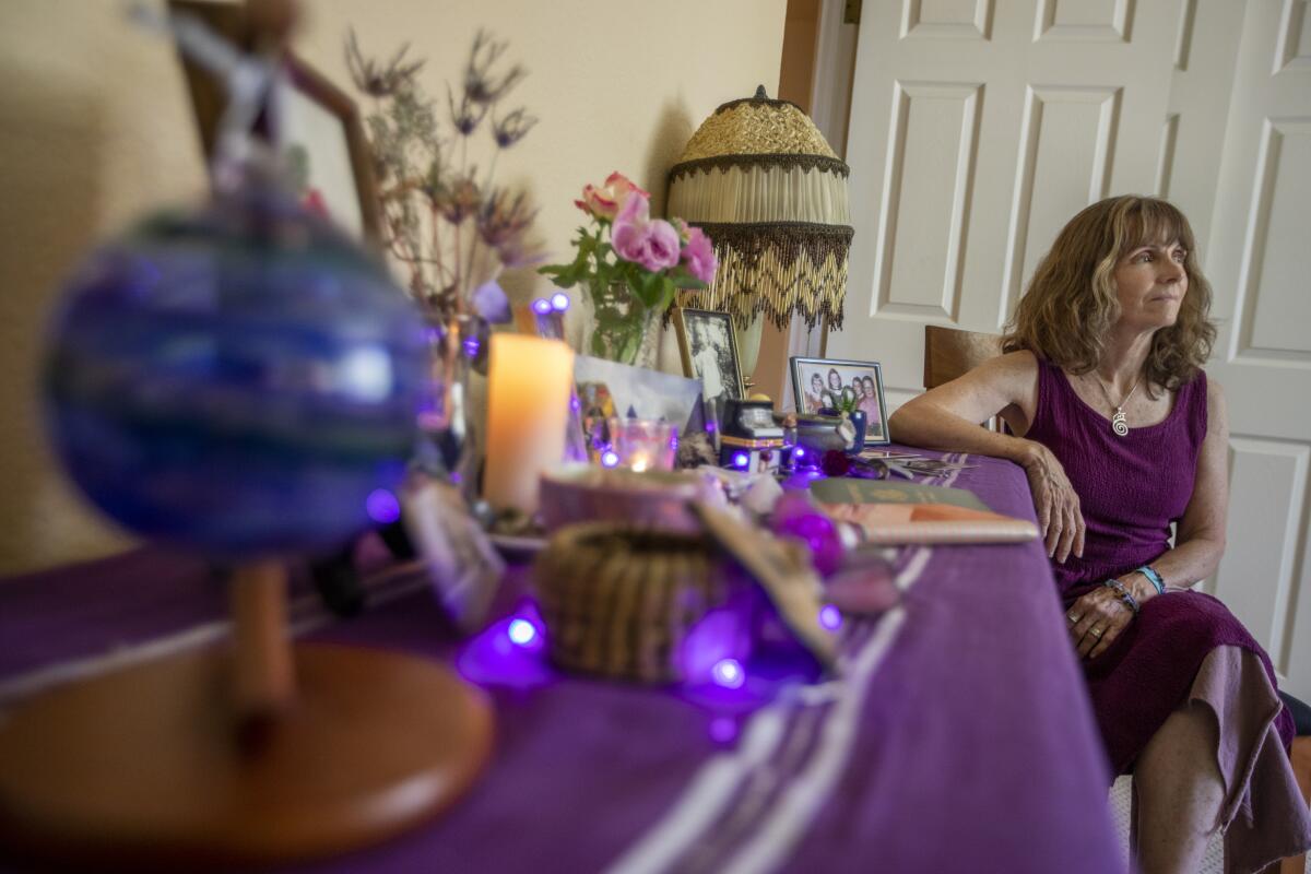 A woman at a table with mementos 