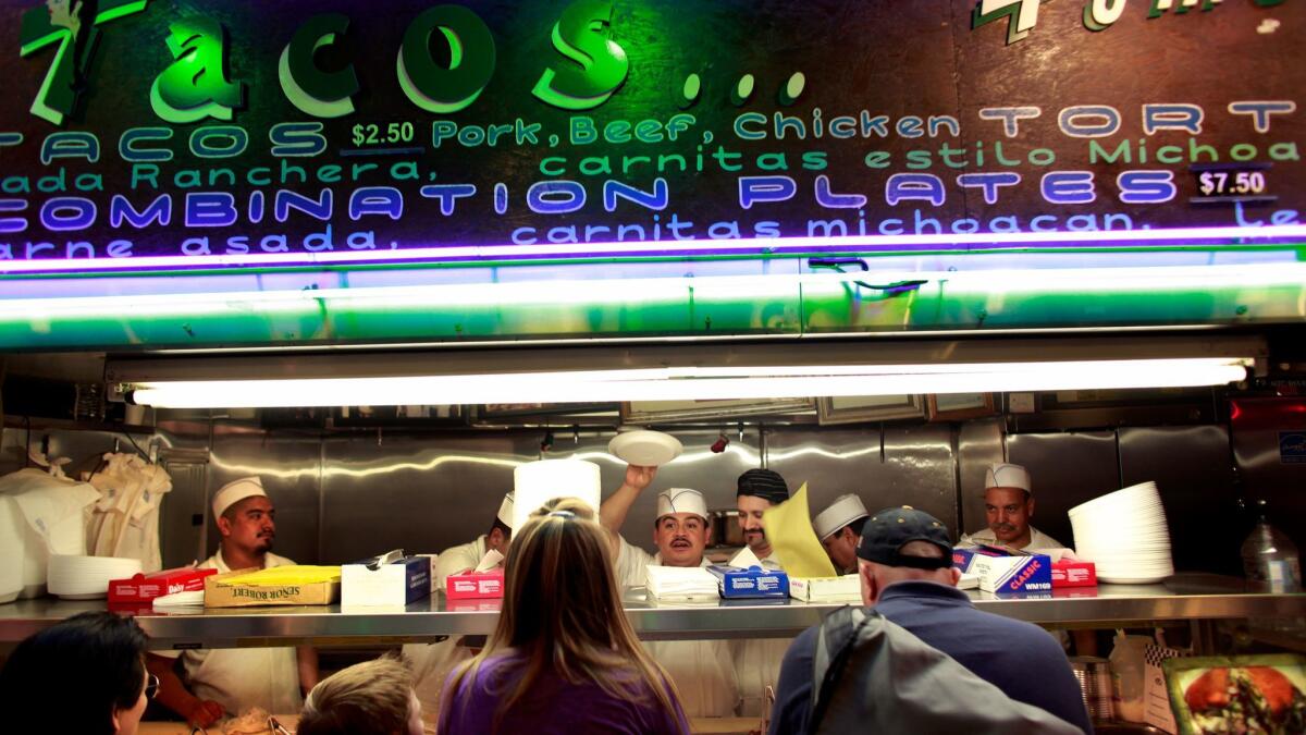 LOS ANGELES, CA --APRIL 19, 2011-- Customers line up in front of Tacos Tumbras a Tomas inside the Grand Central Market in downtown Los Angeles, April 19, 2011. (Jay L. Clendenin/Los Angeles Times)