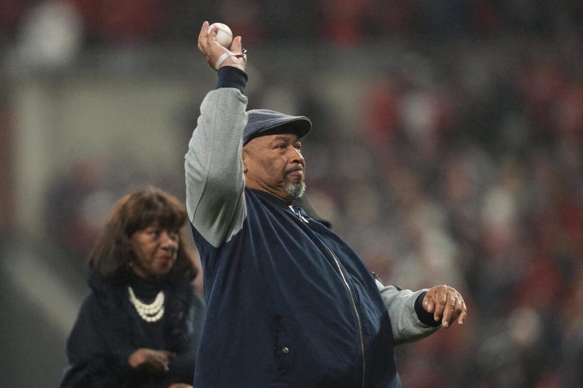 Hank Aaron Jr. throws out the ceremonial first pitch before Game 3 of the World Series on Friday.