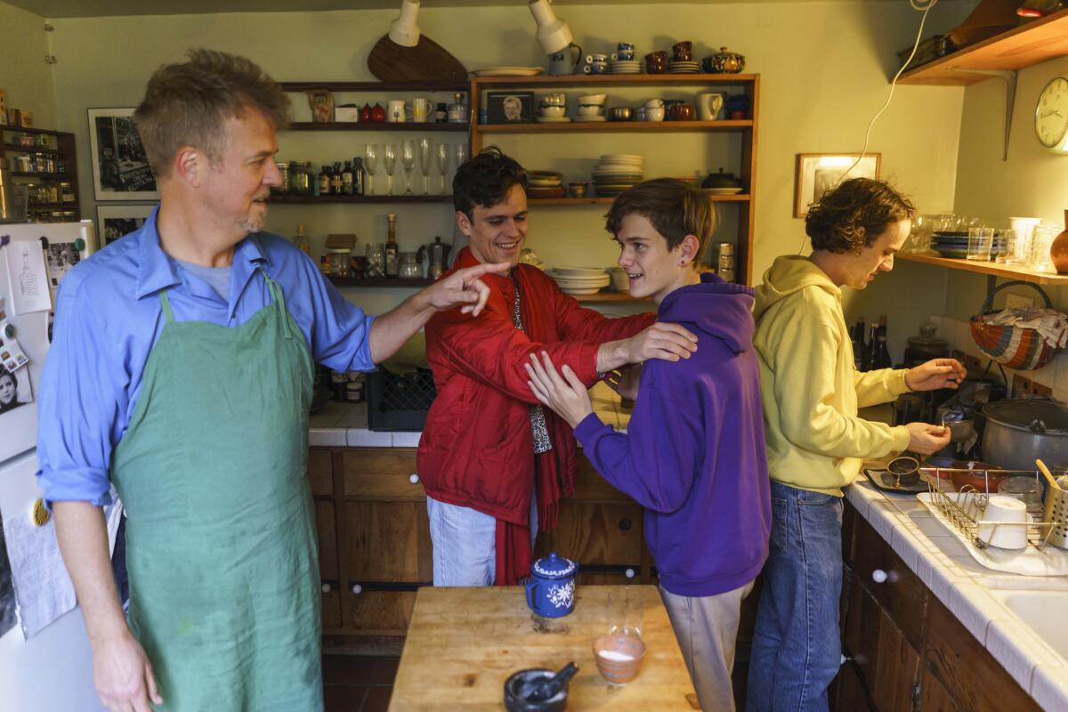 Cal Peternell and his sons Milo Henderson, from left, Liam Peternell, and Henderson Peternell spend time in their kitchen at home in Berkeley, Calif.