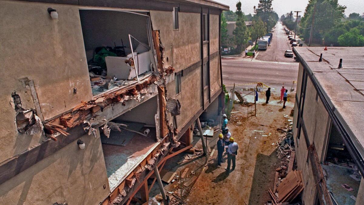 Workers begin to demolish the Northridge Meadows apartment building, whose ground floor collapsed in the 1994 earthquake. (Richard Derk / MCT)