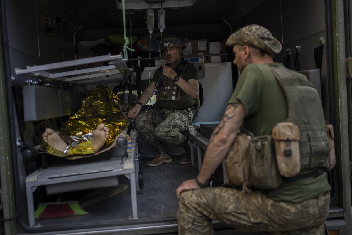 Ukrainian servicemen with an injured comrade