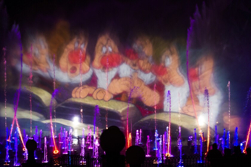 An image from "Snow White and the Seven Dwarfs" is projected on spraying water in 2015