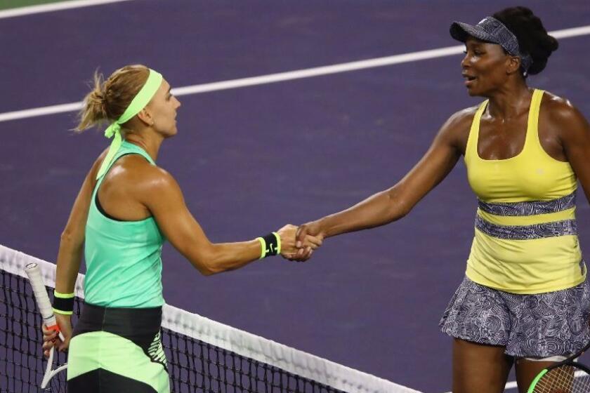 Elena Vesnina shakes hands at the net after her three-set victory over Venus Williams in a BNP Paribas Open quarterfinal match on March 16.