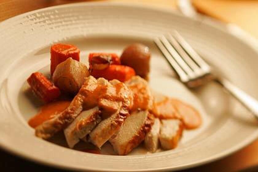 SUNDAY DINNER: Chicken coated with yogurt, thyme and coriander is roasted with carrots, shallots and red peppers. Purée the peppers with goat cheese for a sumptuous sauce that does double-duty as a sandwich spread.