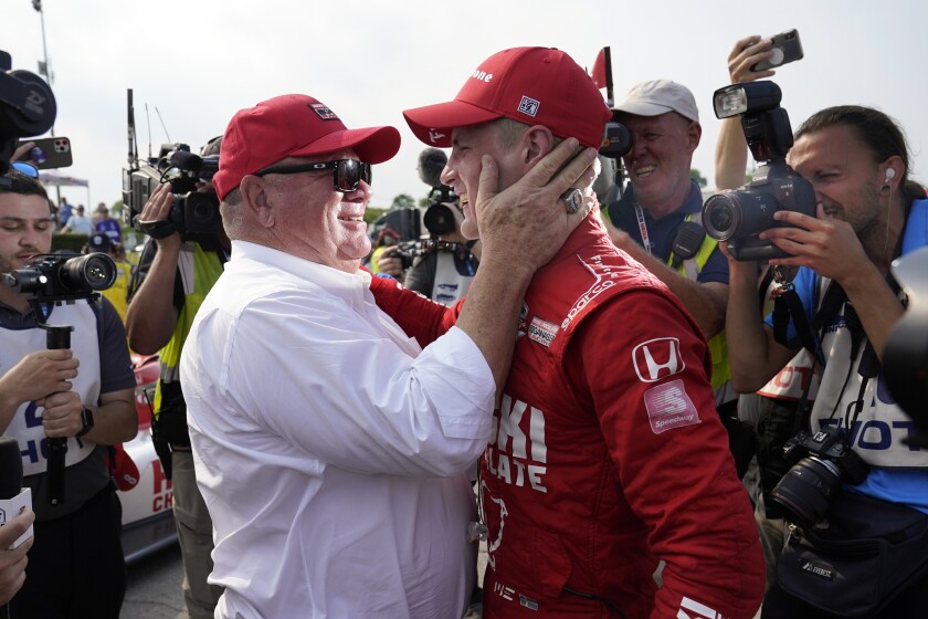 Marcus Ericsson, right, of Sweden, celebrates with team owner Chip Ganassi after winning the first race of the IndyCar Detroit Grand Prix auto racing doubleheader on Belle Isle in Detroit, Saturday, June 12, 2021. (AP Photo/Paul Sancya)