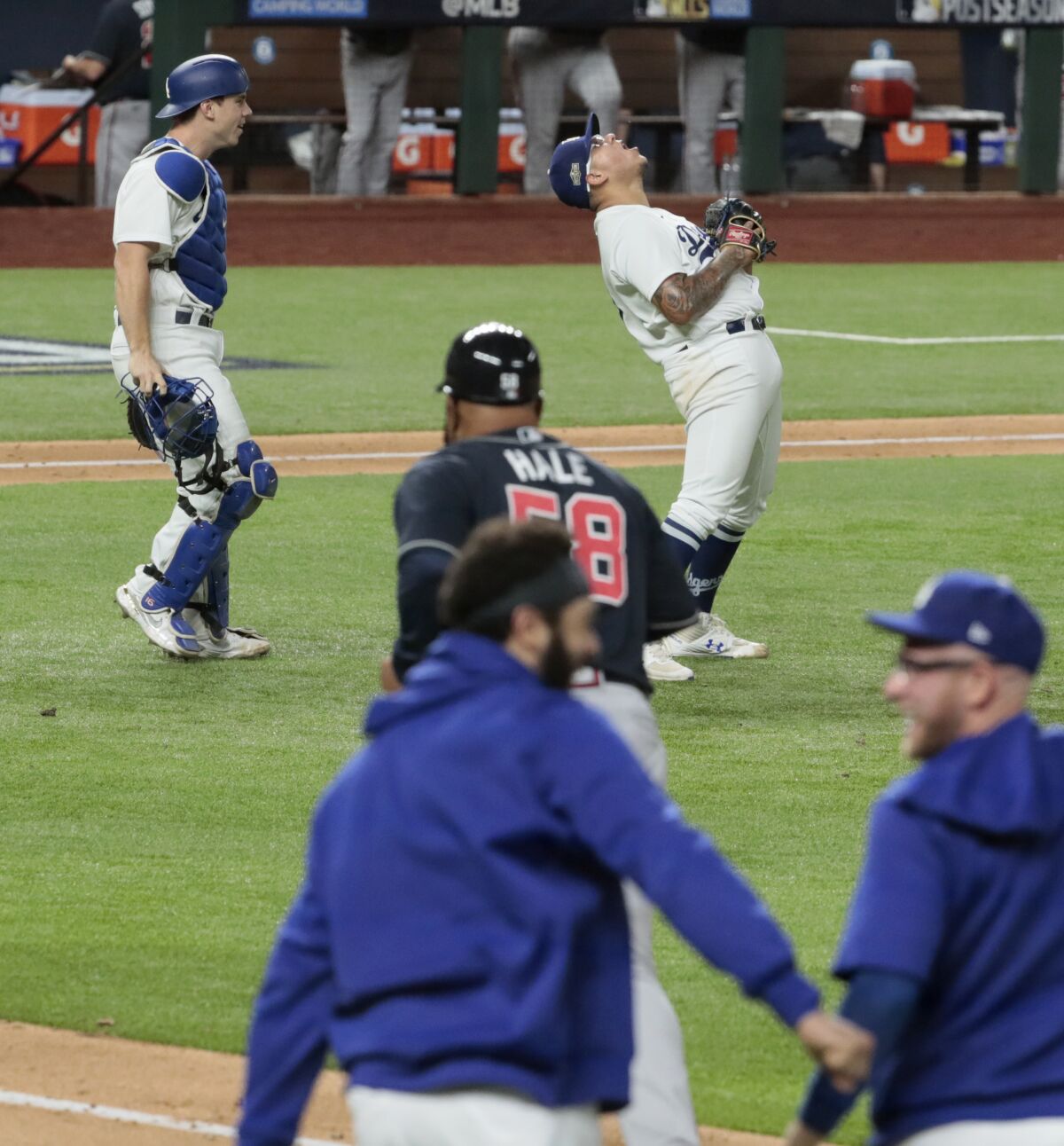 Julio Urías celebrates after the final out of the Dodgers' 4-3 win against the Atlanta Braves.