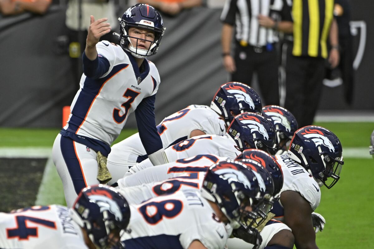Denver Broncos quarterback Drew Lock prepares to snap the ball during a game against the Las Vegas Raiders.