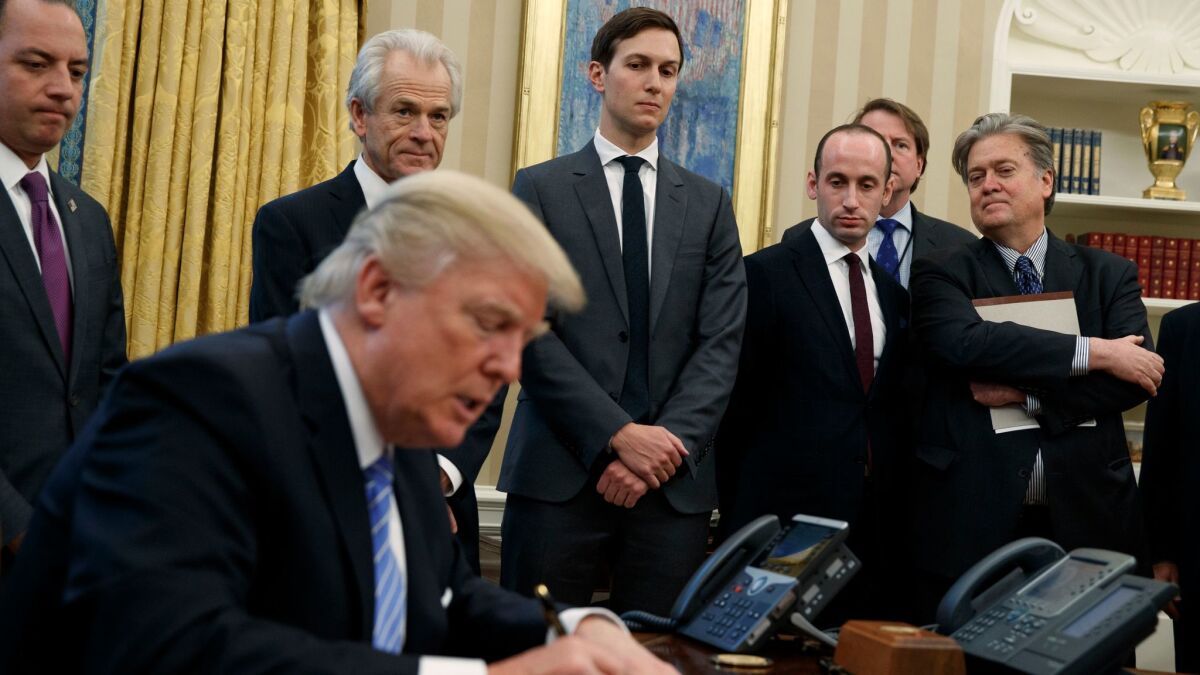 Among President Trump's top advisors are Stephen K. Bannon, far right, and Stephen Miller, to Bannon's right.