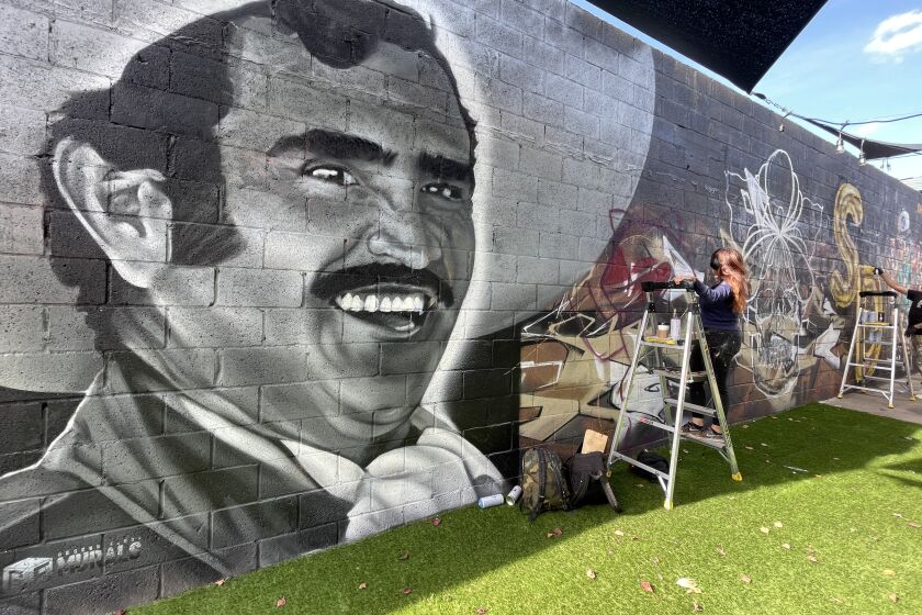 Vicente Fernández's mural (left) by Ground Floor Murals, located inside the Imperial Avenue CoLab in Sherman Heights