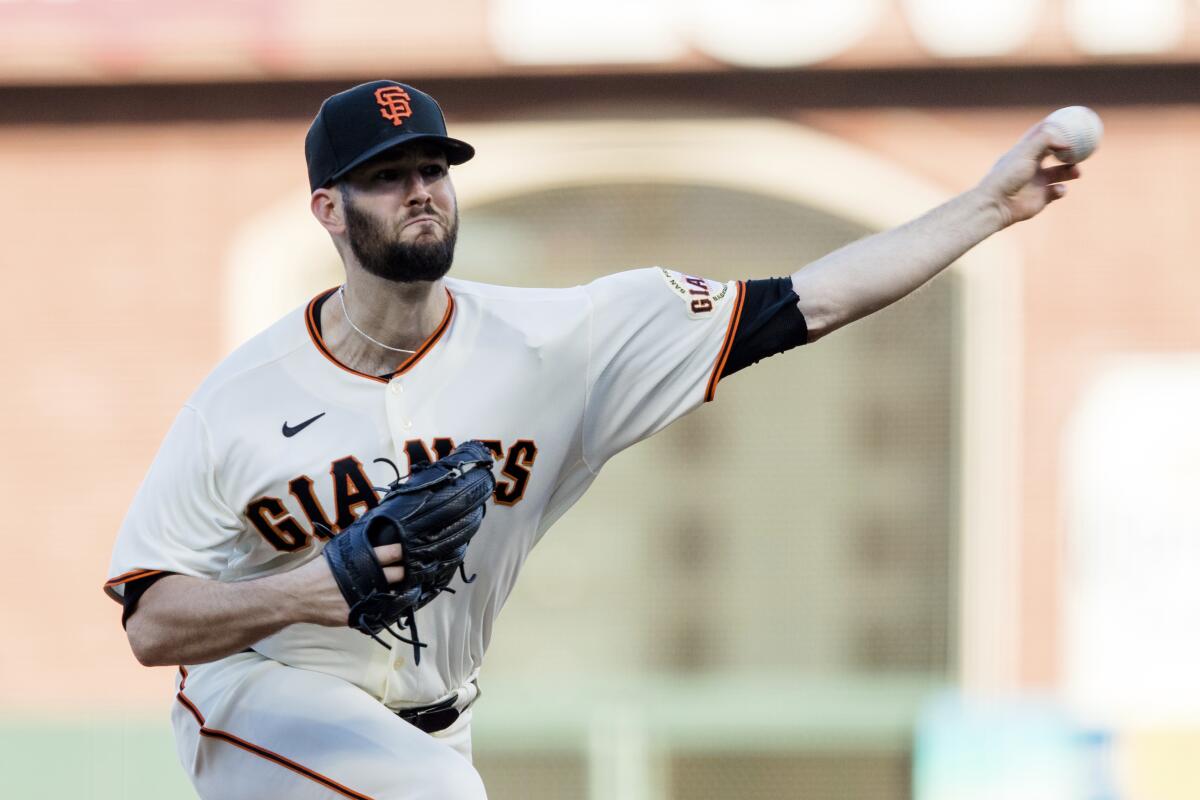 San Francisco Giants starting pitcher Alex Wood throws against the Texas Rangers during the first inning of a baseball game in San Francisco, Monday, May 10, 2021. (AP Photo/John Hefti)