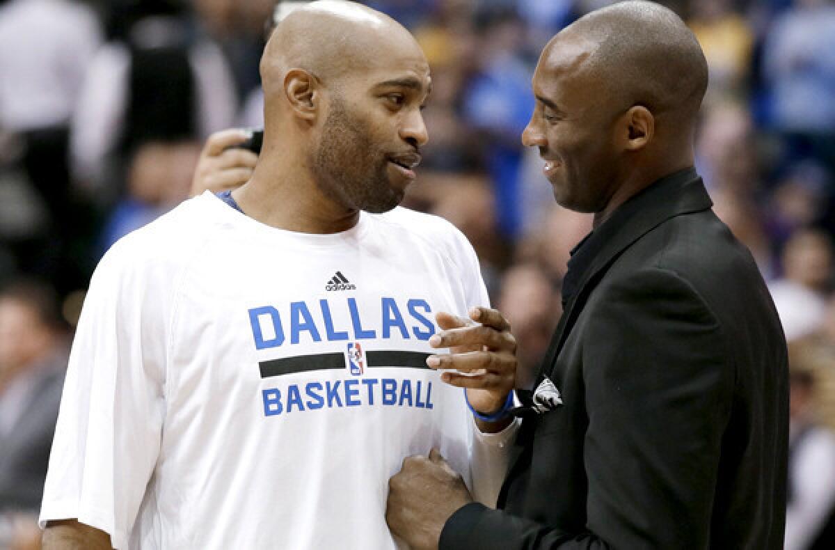 Lakers All-Star Kobe Bryant greets Mavericks veteran Vince Carter before a game earlier this season in Dallas.