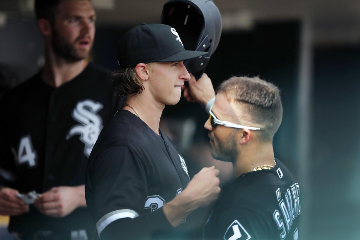 White Sox starter Michael Kopech, left, is embraced by teammate Yolmer Sanchez after being relieved during the seventh inning against the Tigers, Sunday, Aug. 26, 2018, in Detroit.