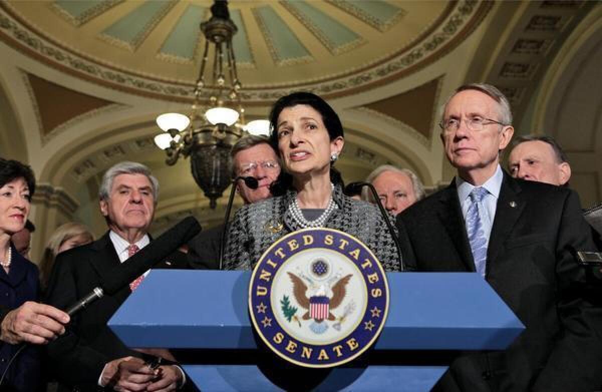 Olympia Snowe, center, then a Republican senator from Maine, talks in 2009 about a bipartisan compromise on the $789-billion economic stimulus measure.