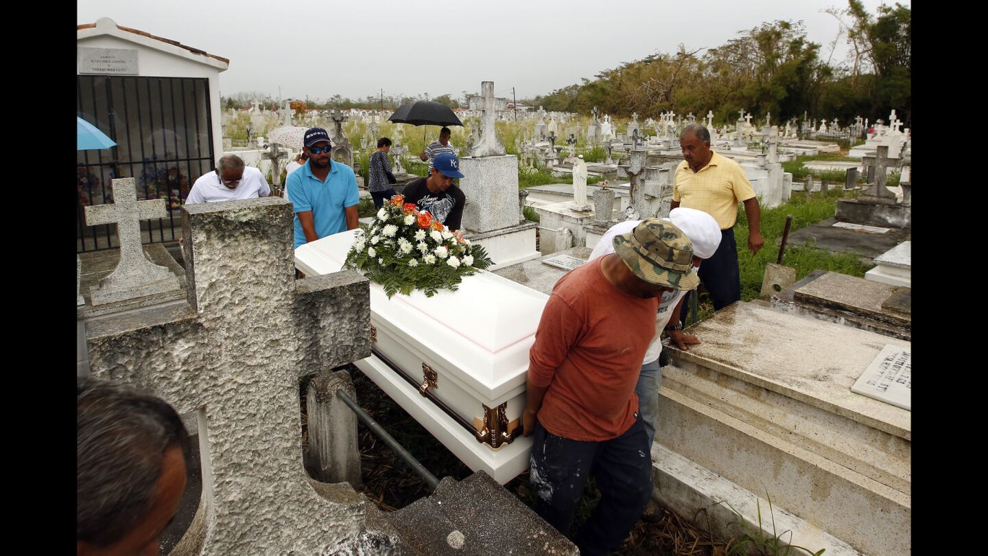 The coffin of Norma Casiano Rivera is carried to the gravesite at the Lajas municipal cemetery, where more than five people have been buried since Hurricane Maria.