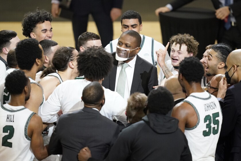 Cleveland State head coach Dennis. Gates celebrates with is team following an NCAA college basketball game in the men's Horizon League conference tournament championship game against Oakland, Tuesday, March 9, 2021, in Indianapolis. Cleveland State won 80-69 (AP Photo/Darron Cummings)