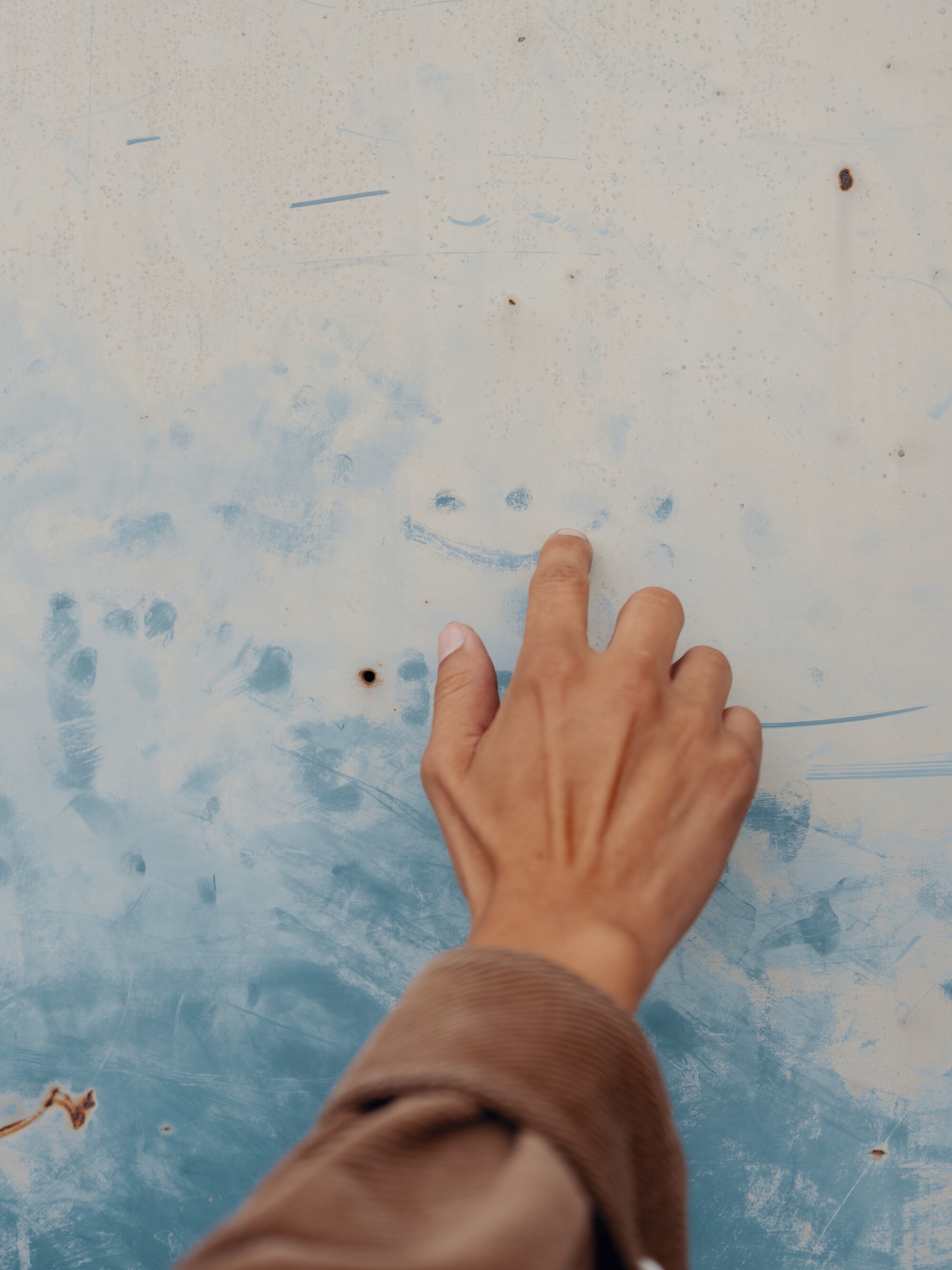 Preciado draws a smiley face in the dust on his vintage truck.